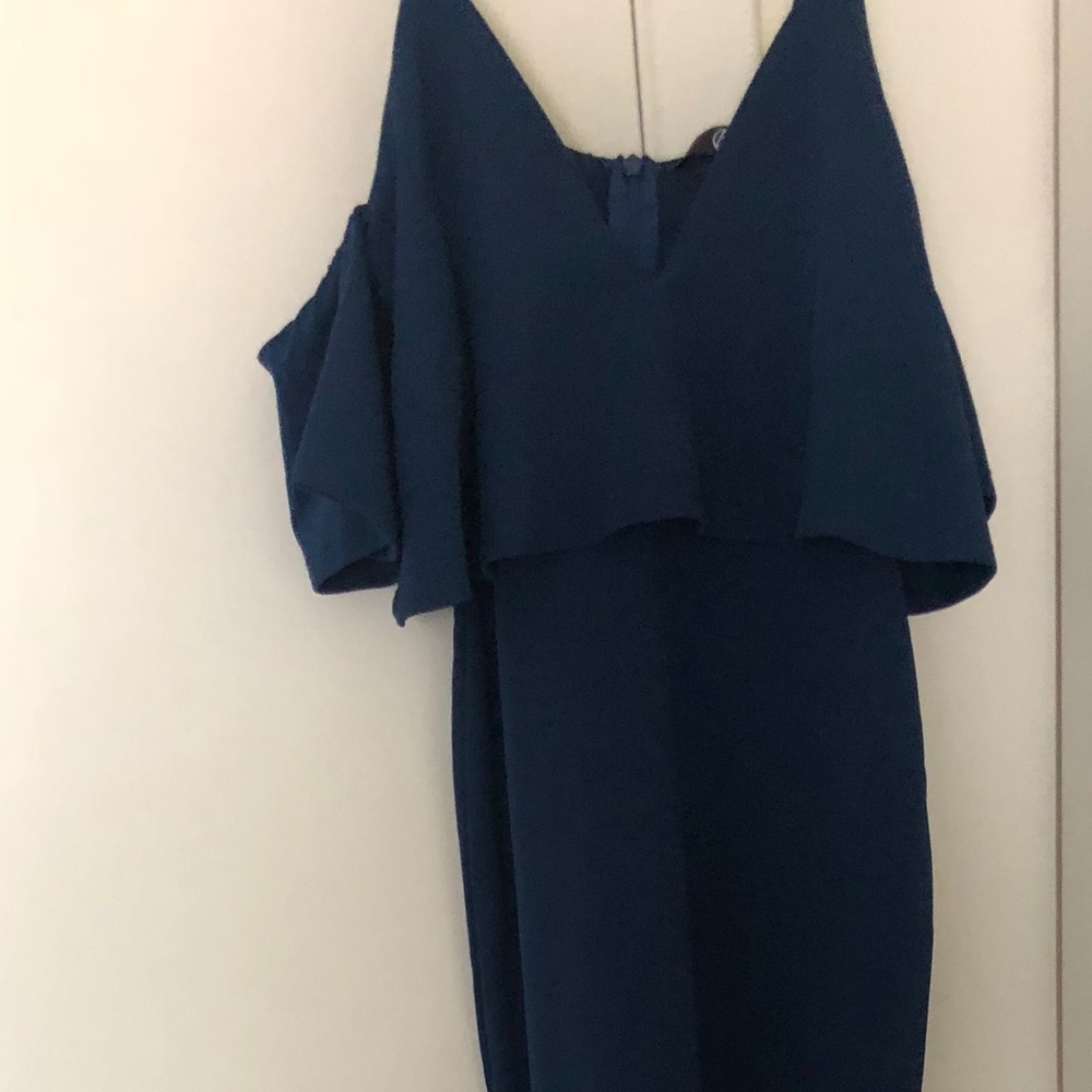 Long blue dress with ruffle sleeves.